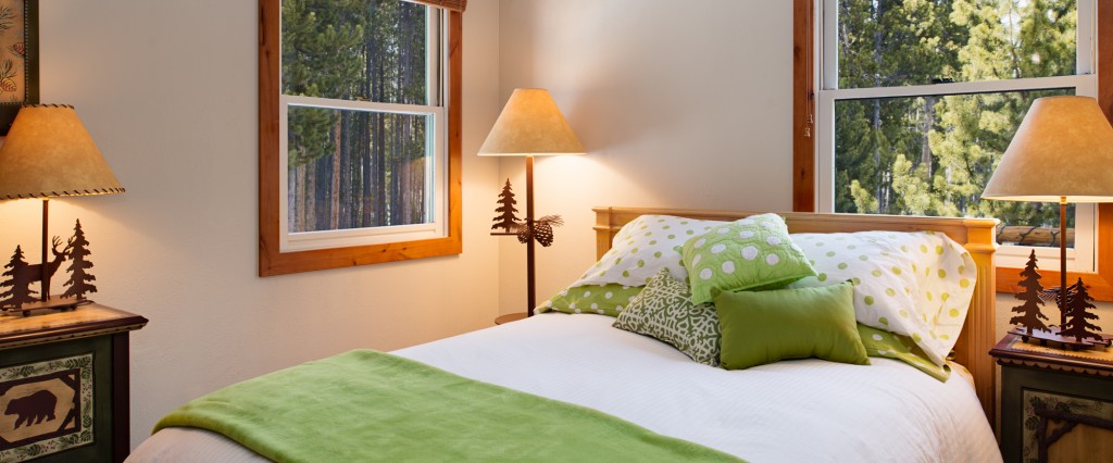 Main floor bedroom — all new luxury bedding and a view to the surrounding pines