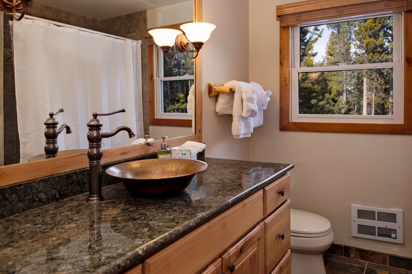 Main floor bathroom with bath/shower and abundant soft and fluffy towels