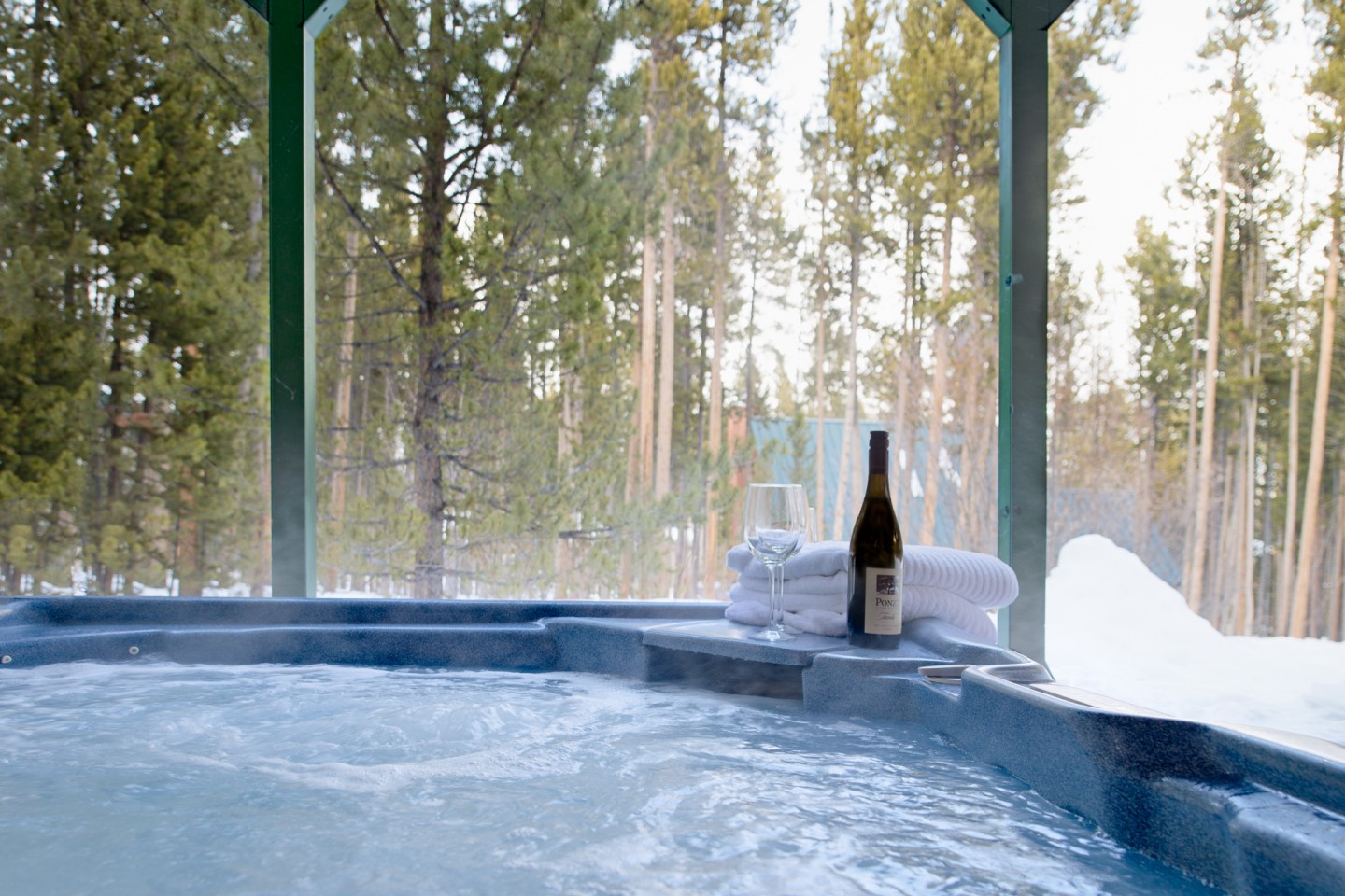 Private hot tub with a view to the surrounding pines ... your seat in the hot tub awaits