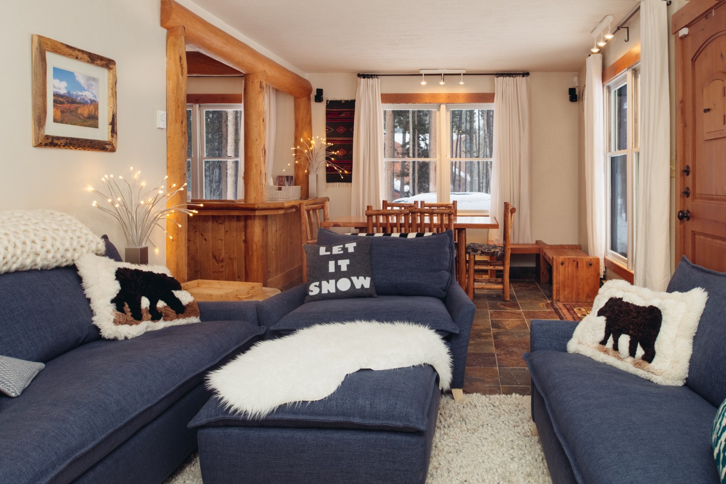 The cabin living room looking over to the dining area